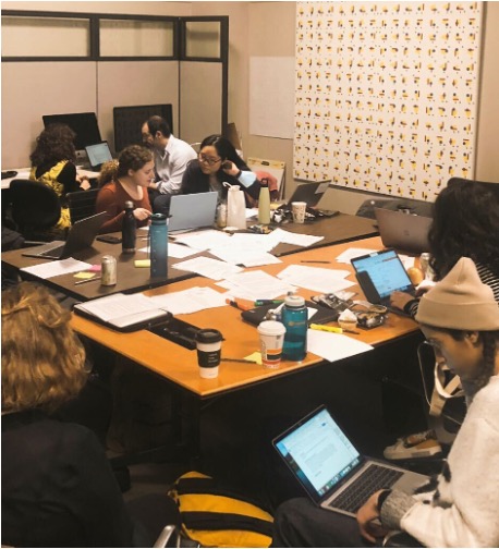A photograph of atendees involving many graduate students working with their peers 